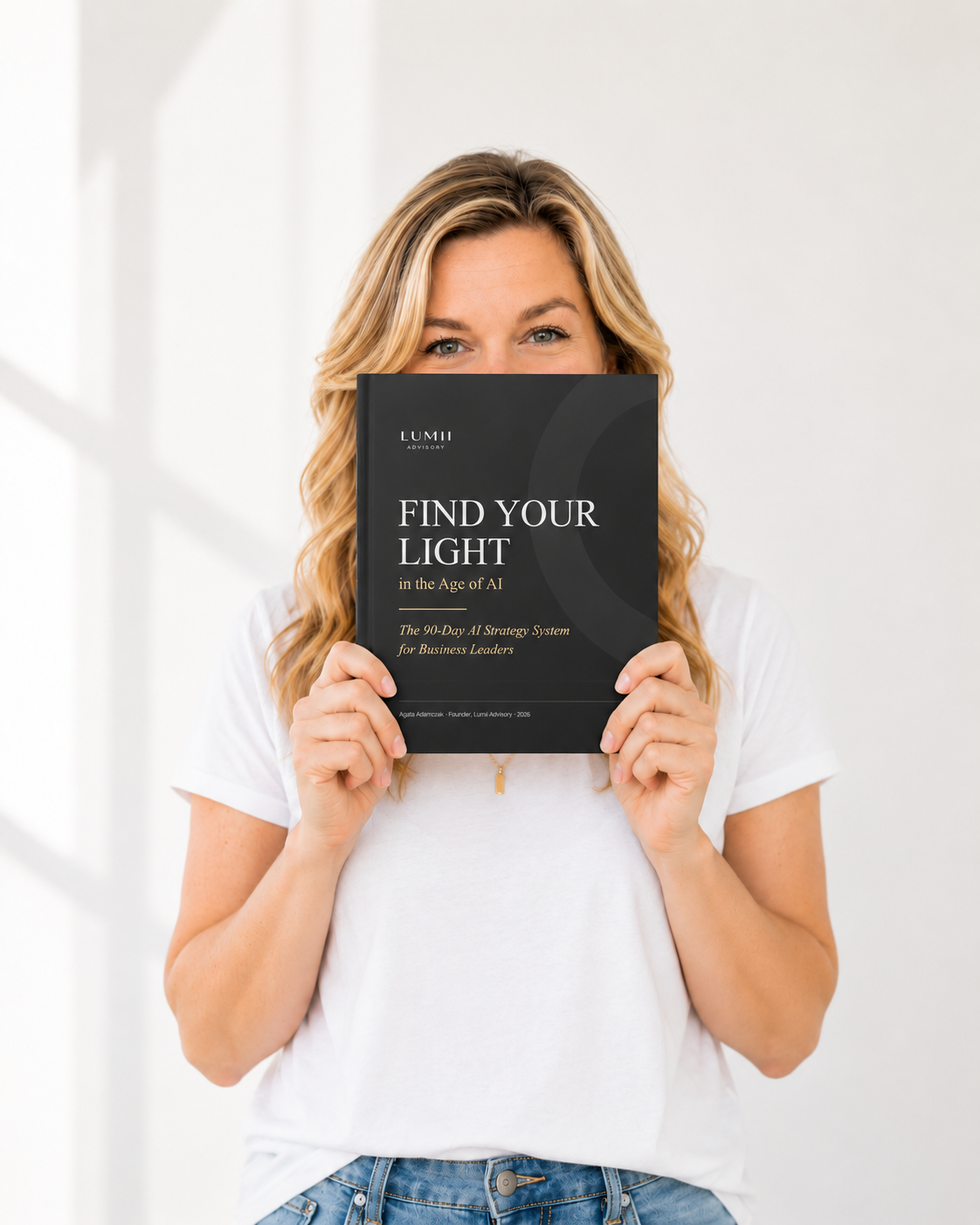 Agata Adamczak holding the Find Your Light in the Age of AI ebook